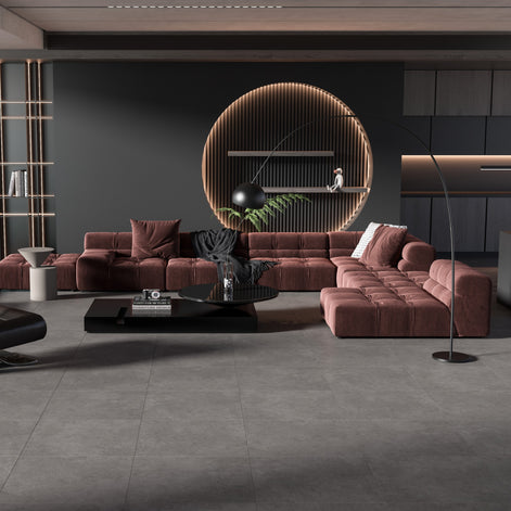Modern living room with brown sectional sofa, dark coffee table, and decorative elements. Dark grey floor tile