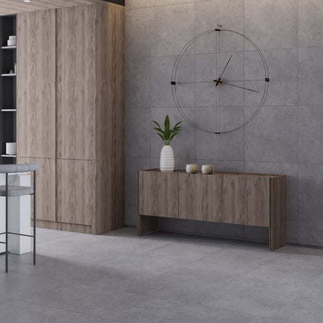 Modern interior with wooden furniture, a clock, and decorative items on a gray tiled wall.